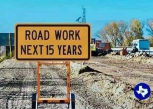 Two tradesman set up for road work: one a veteran and the other a literalist rookie