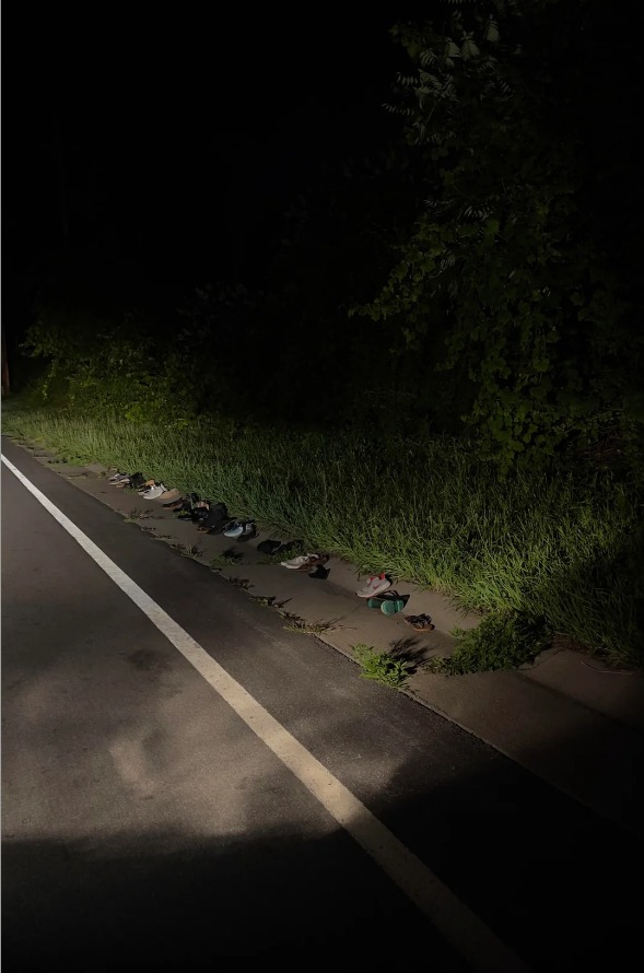 Driving at Night and I Stumbled Across a Line of Children’s Shoes by the Woods 